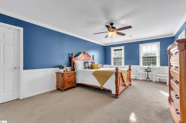 bedroom with ornamental molding, carpet, and ceiling fan