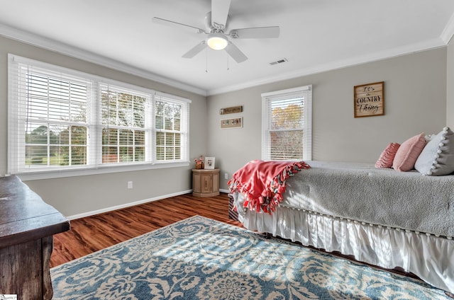 bedroom with ceiling fan, ornamental molding, dark hardwood / wood-style floors, and multiple windows