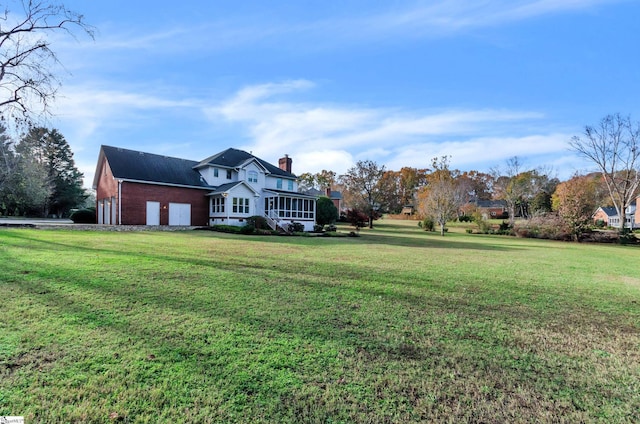 view of front of property featuring a front yard and a sunroom