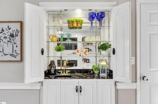 bar with sink and white cabinets