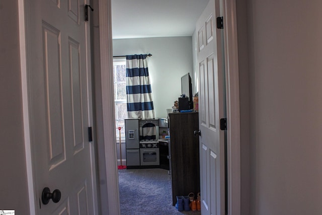 corridor featuring dark colored carpet