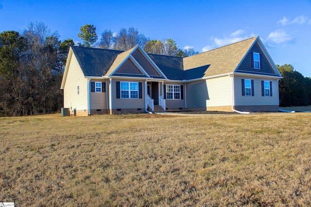 view of front of house with central air condition unit and a front lawn