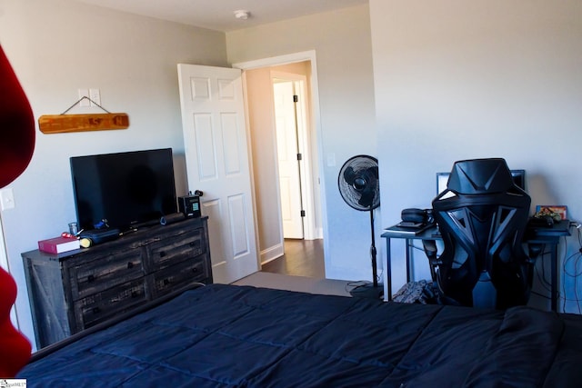 bedroom with dark wood-type flooring