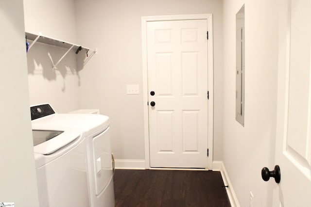 clothes washing area with dark hardwood / wood-style flooring and washer and clothes dryer