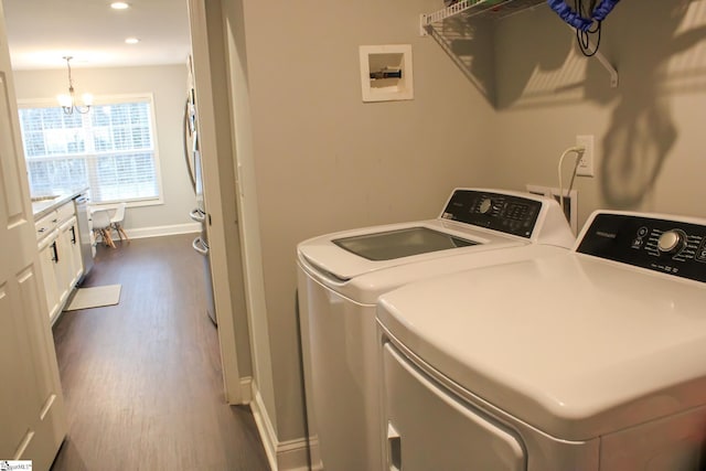 laundry room with a chandelier, dark hardwood / wood-style floors, and separate washer and dryer