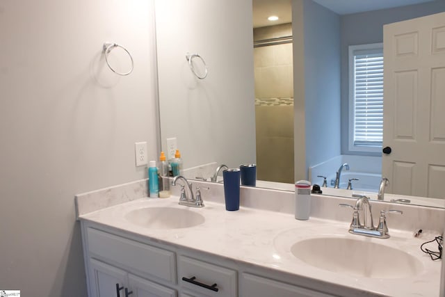 bathroom with vanity and a bath