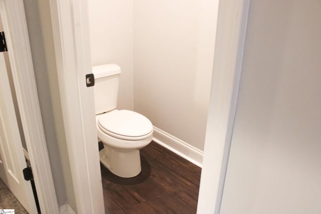 bathroom featuring hardwood / wood-style flooring and toilet