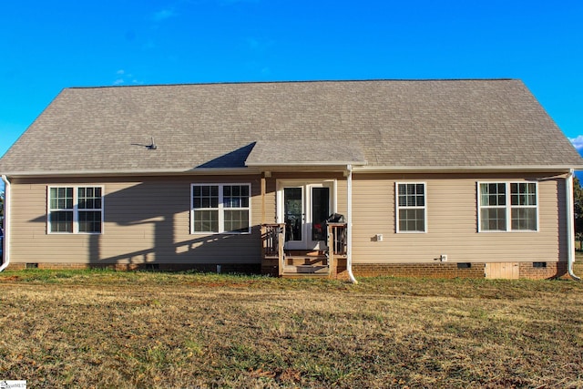 rear view of property with a lawn