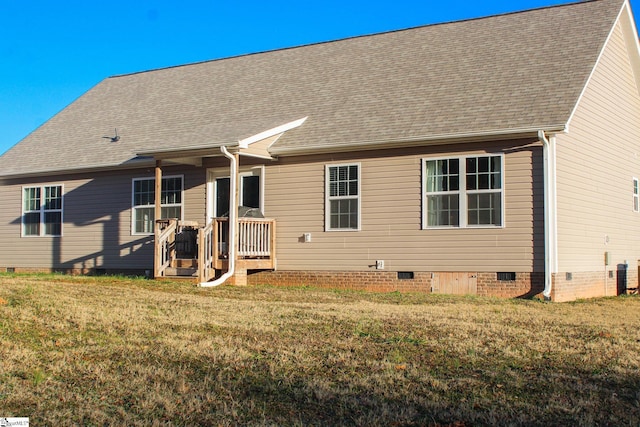 rear view of house with a yard