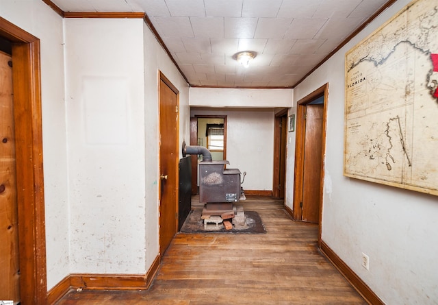 hallway with crown molding and hardwood / wood-style floors