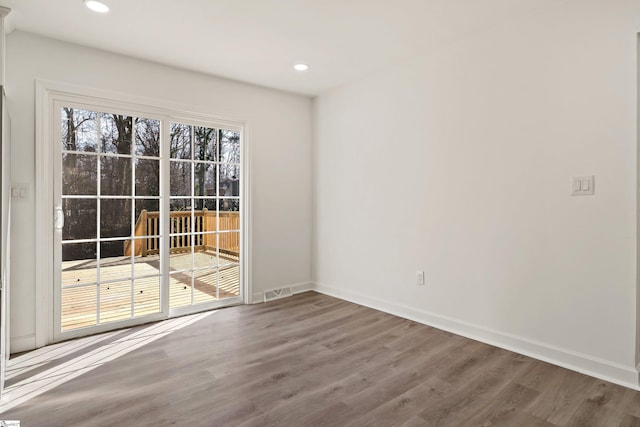 spare room featuring hardwood / wood-style floors