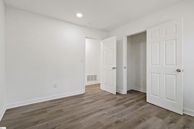 unfurnished bedroom with wood-type flooring