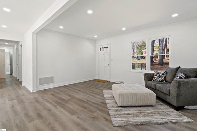 living room with ornamental molding and hardwood / wood-style floors