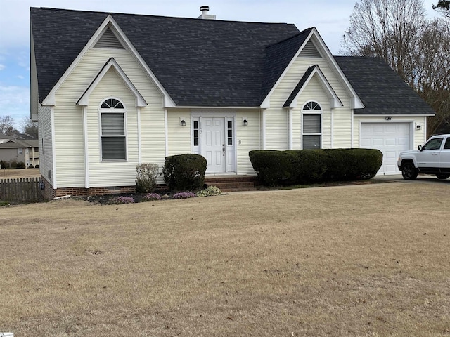 view of front of property featuring a garage and a front yard