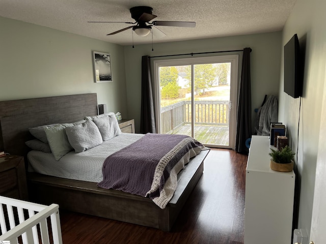 bedroom featuring dark wood-type flooring, ceiling fan, access to exterior, and a textured ceiling