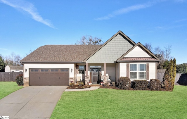 craftsman-style home featuring a front yard and a garage