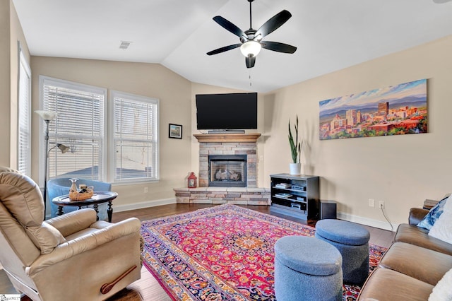 living room featuring hardwood / wood-style floors, lofted ceiling, ceiling fan, and a fireplace