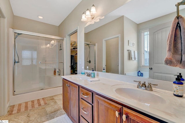 bathroom featuring vanity and a shower with door