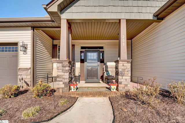 property entrance with covered porch and a garage