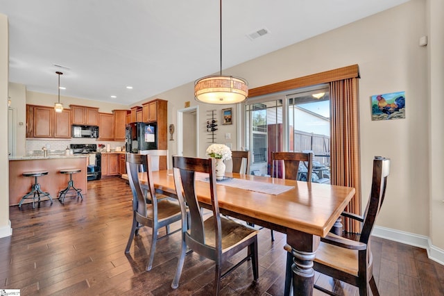 dining space featuring dark hardwood / wood-style floors