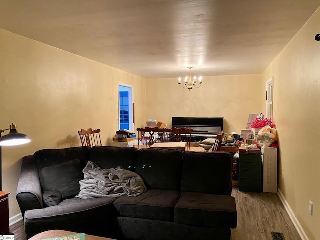 living room featuring wood-type flooring and a chandelier