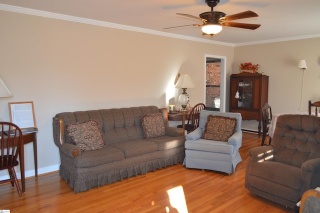 living room featuring crown molding, ceiling fan, and light wood-type flooring