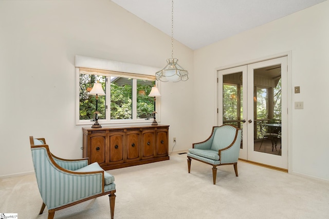 sitting room with light carpet, vaulted ceiling, and french doors