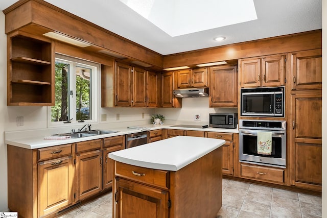 kitchen with a kitchen island, sink, black appliances, and light tile patterned floors