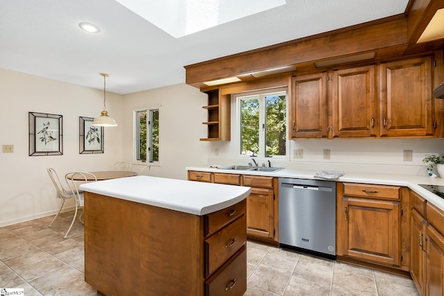 kitchen featuring decorative light fixtures, a kitchen island, sink, stainless steel dishwasher, and light tile patterned floors