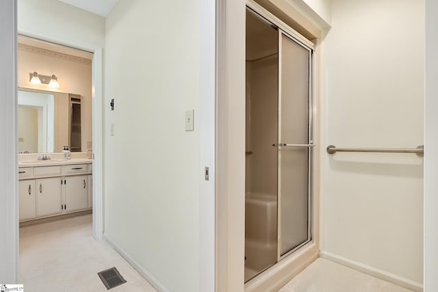 bathroom with vanity and an enclosed shower