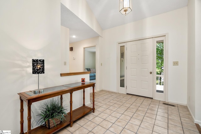 tiled foyer entrance with vaulted ceiling