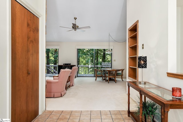 interior space with ceiling fan and light colored carpet