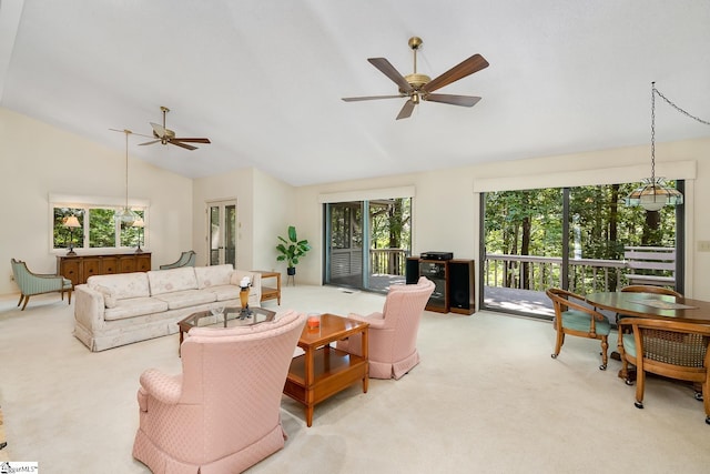 carpeted living room with high vaulted ceiling, plenty of natural light, and ceiling fan