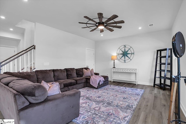 living room featuring hardwood / wood-style flooring and ceiling fan