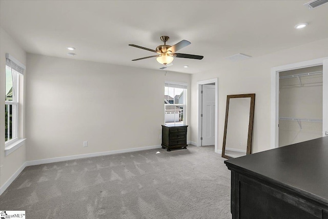 unfurnished bedroom with ceiling fan and light colored carpet