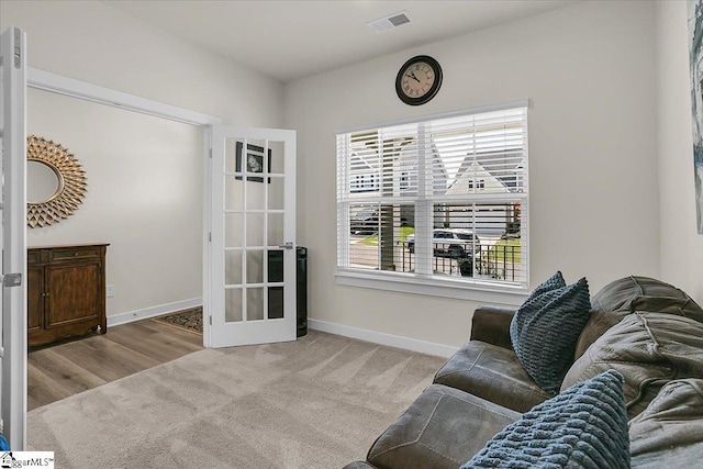 sitting room featuring light carpet