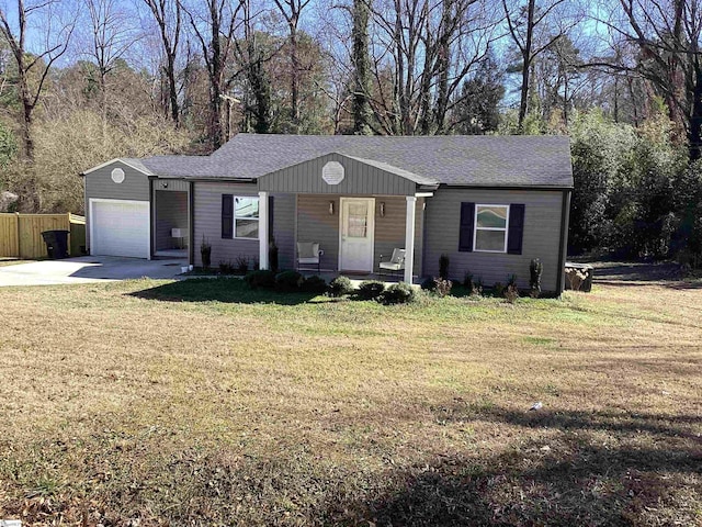 single story home with covered porch, a front lawn, and a garage