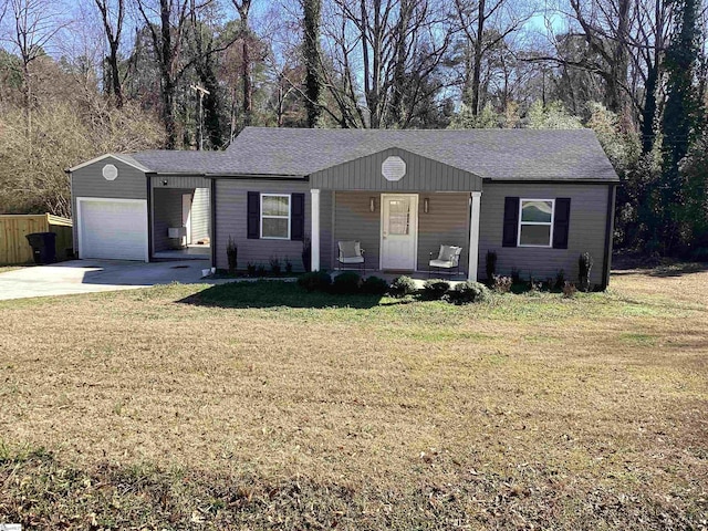 single story home featuring covered porch, a front yard, and a garage