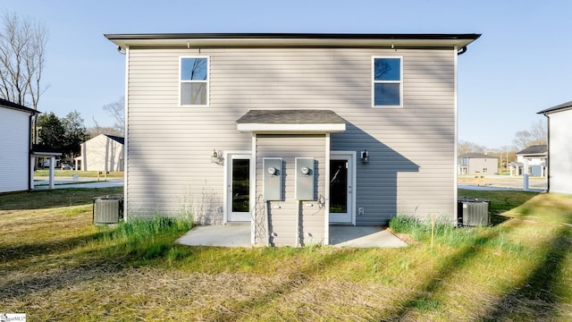 rear view of house featuring a patio and central air condition unit