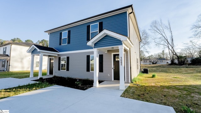 view of front of property featuring central AC unit and a front lawn