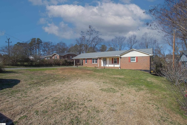 ranch-style house with covered porch and a front lawn