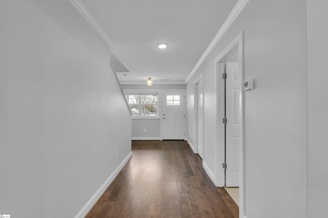 hall with dark hardwood / wood-style floors and ornamental molding