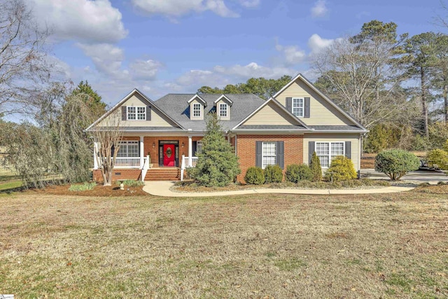 view of front of property with covered porch and a front lawn