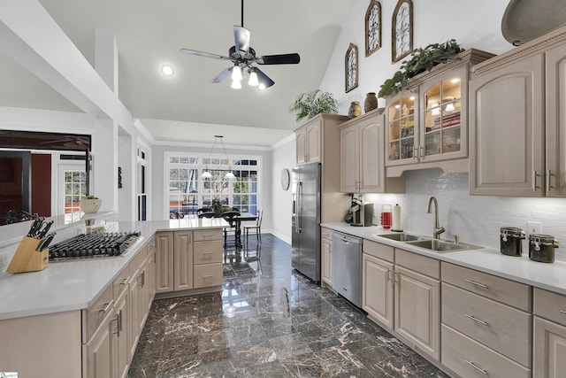 kitchen featuring stainless steel appliances, sink, ornamental molding, light brown cabinetry, and decorative backsplash