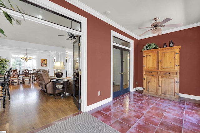 interior space featuring french doors, ornamental molding, and ceiling fan with notable chandelier