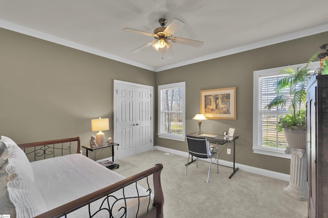 bedroom with light carpet, multiple windows, a closet, and crown molding