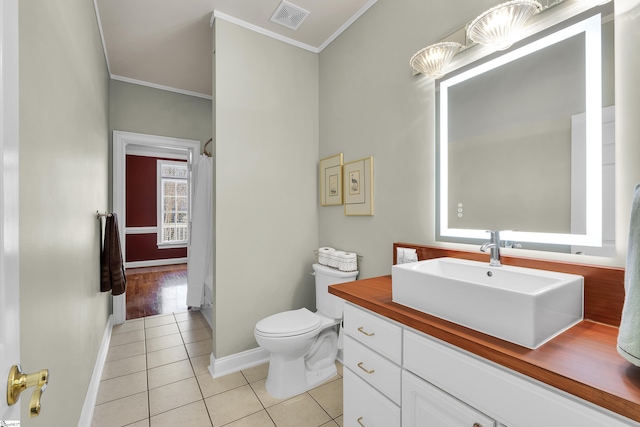 bathroom featuring vanity, crown molding, toilet, and tile patterned floors