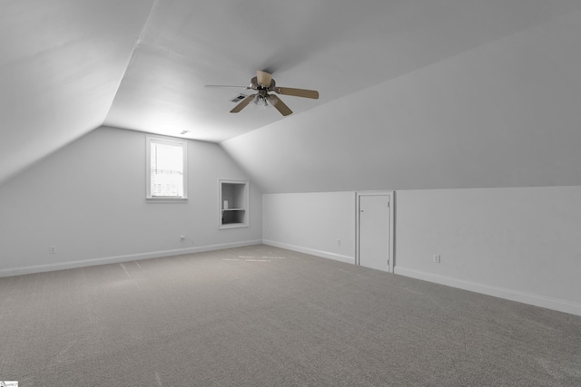 additional living space featuring ceiling fan, vaulted ceiling, and carpet floors