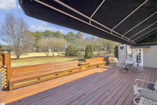 wooden deck featuring a lawn