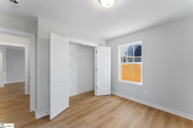 unfurnished bedroom featuring a closet and light hardwood / wood-style flooring